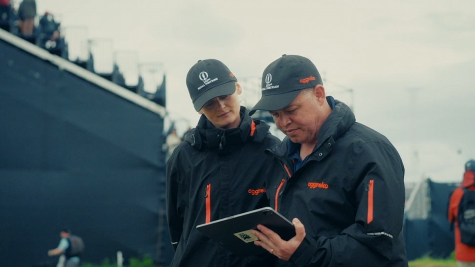 Still from the Aggreko end of year wrap: crowds walking towards the R&A pavilion at a golf championship.