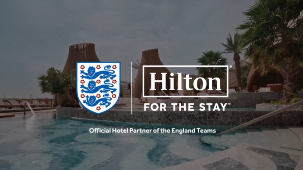 Still from the Hilton FA showcase: players celebrating arm in arm on the pitch.